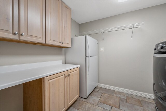 laundry area with washer / dryer and cabinets