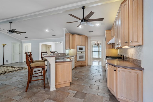 kitchen with kitchen peninsula, white appliances, a kitchen breakfast bar, light brown cabinetry, and sink