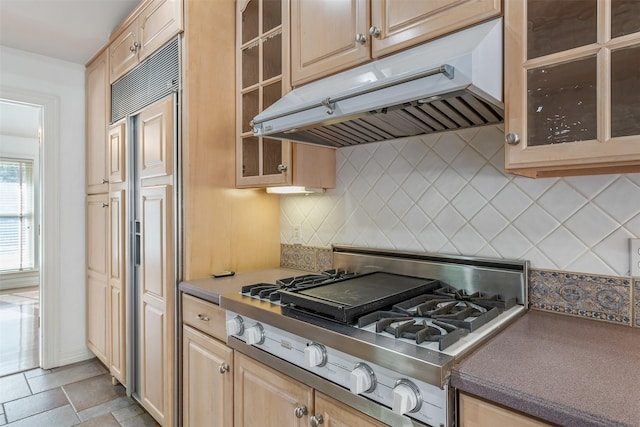 kitchen featuring light brown cabinets, stainless steel gas cooktop, paneled built in fridge, and backsplash