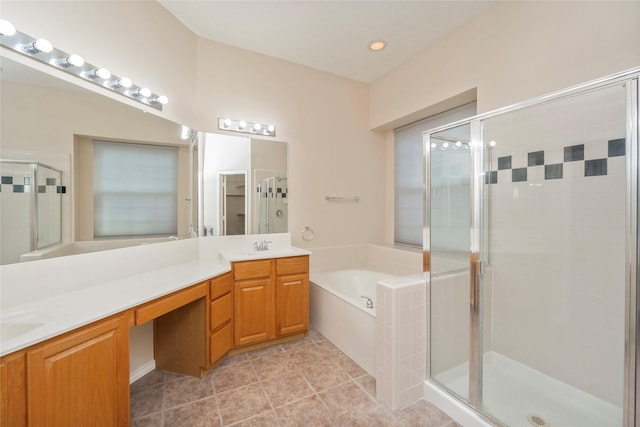 bathroom with vanity and shower with separate bathtub