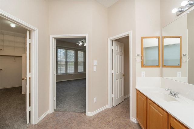 bathroom featuring ceiling fan, vanity, and tile patterned floors