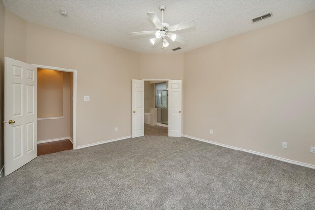 bathroom with tile patterned floors, a shower with door, toilet, and vanity