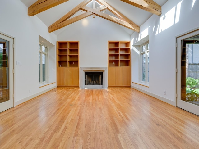 unfurnished living room featuring beam ceiling, hardwood / wood-style flooring, and high vaulted ceiling