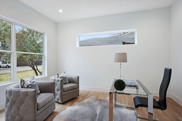 home office with light hardwood / wood-style floors