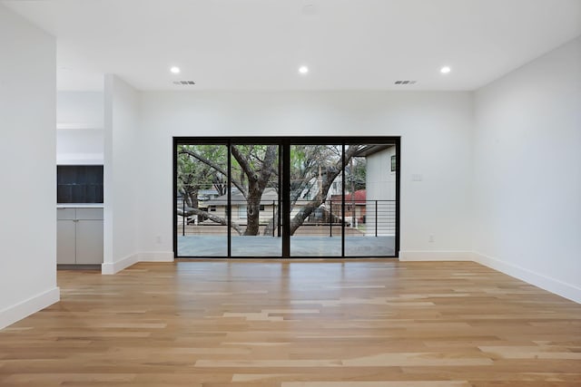 spare room featuring light hardwood / wood-style flooring