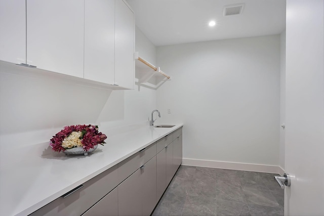 clothes washing area with sink