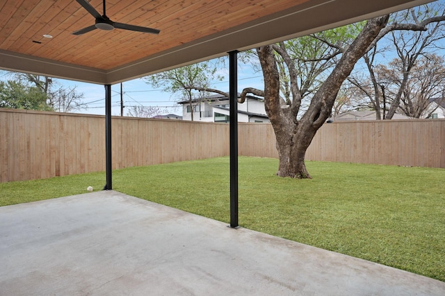 view of yard with ceiling fan and a patio