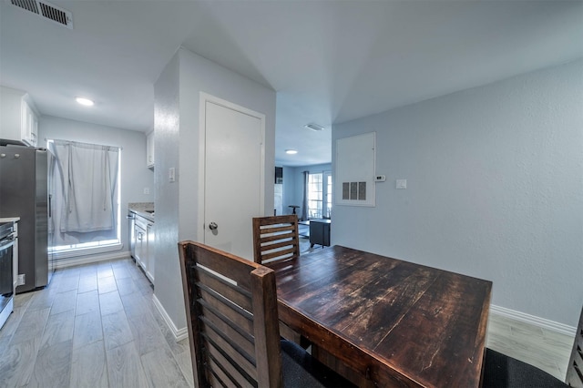 dining space with light hardwood / wood-style flooring