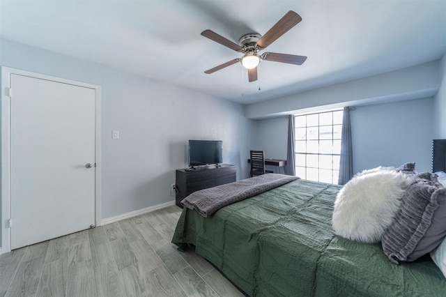 bedroom with ceiling fan and light hardwood / wood-style flooring