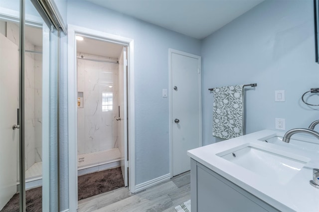 bathroom featuring an enclosed shower and vanity