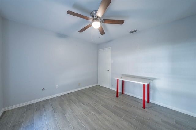 unfurnished room with ceiling fan