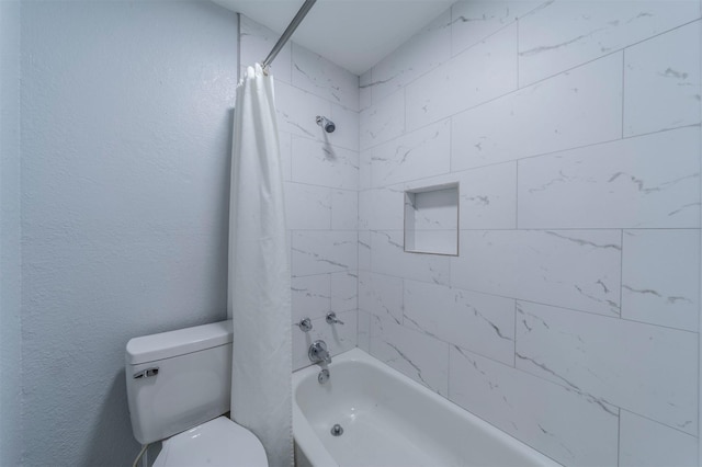 bathroom with toilet and shower / bath combo