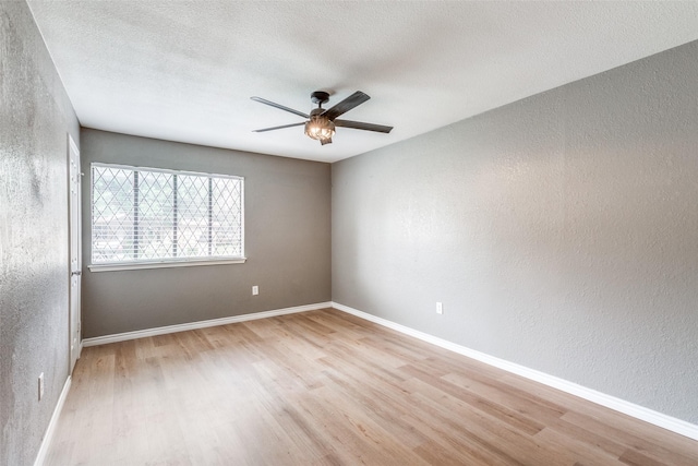 spare room featuring ceiling fan, a textured ceiling, and light hardwood / wood-style flooring