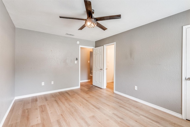 spare room with ceiling fan and light wood-type flooring