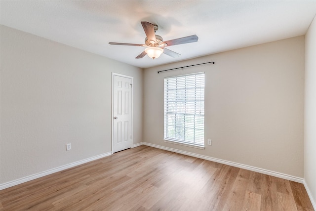 empty room with ceiling fan and light hardwood / wood-style floors