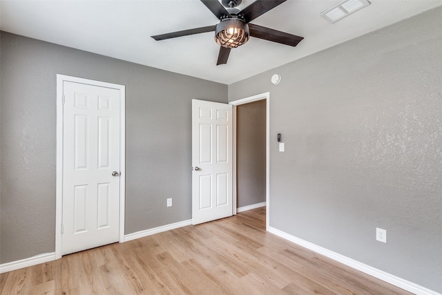 unfurnished bedroom featuring ceiling fan and light hardwood / wood-style flooring