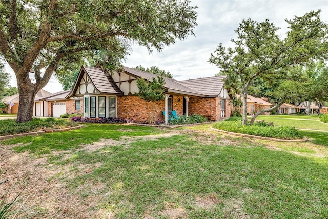 view of front of house with a garage and a front yard