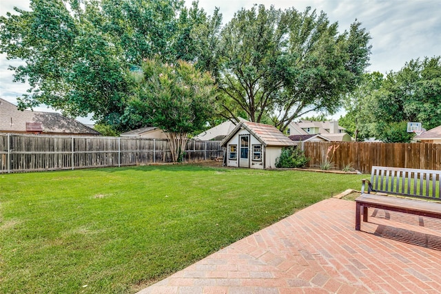 view of yard featuring a patio area and an outdoor structure