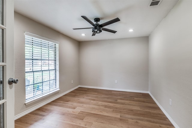 unfurnished room featuring light wood-type flooring and ceiling fan