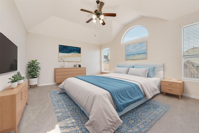 carpeted bedroom with vaulted ceiling and ceiling fan