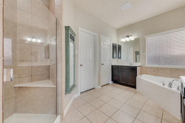 bathroom with shower with separate bathtub, tile patterned floors, and vanity