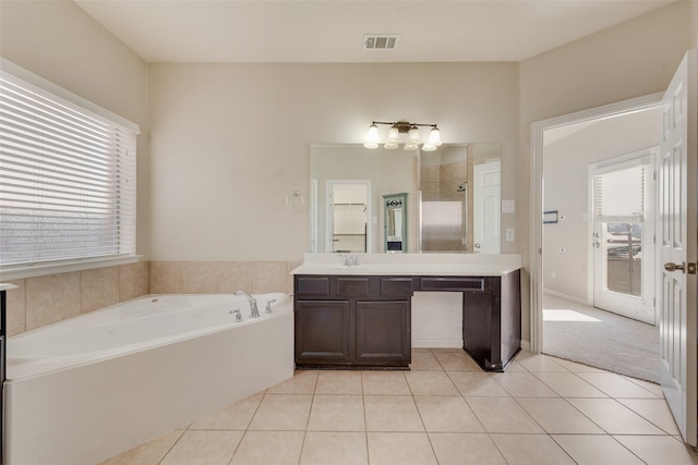 bathroom with vanity, a bath, and tile patterned flooring