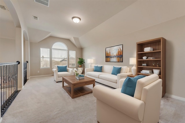 carpeted living room with lofted ceiling