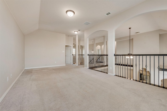 unfurnished room featuring vaulted ceiling and carpet floors