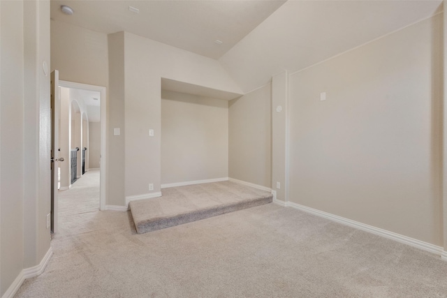 basement featuring light colored carpet