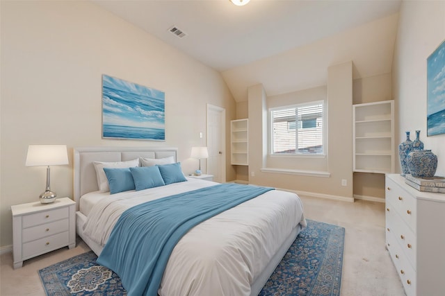 bedroom featuring lofted ceiling and light colored carpet