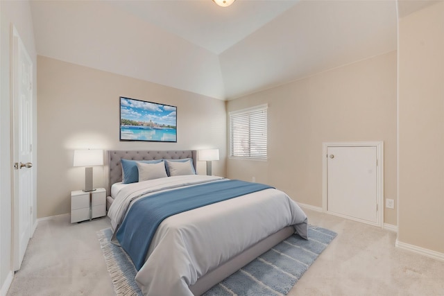 bedroom featuring lofted ceiling and light colored carpet