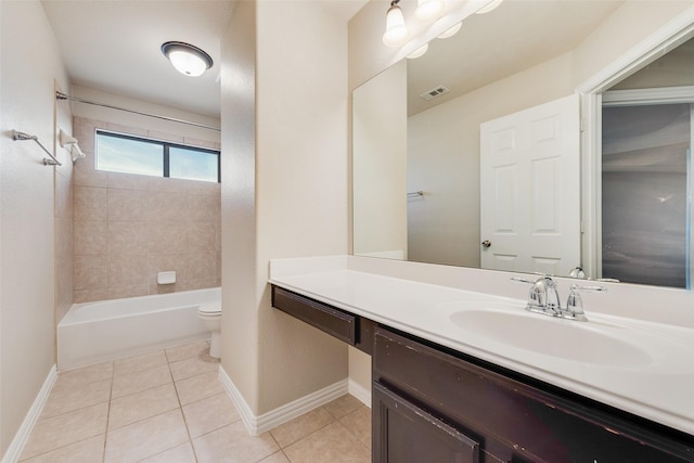 full bathroom featuring toilet, tiled shower / bath, tile patterned floors, and vanity