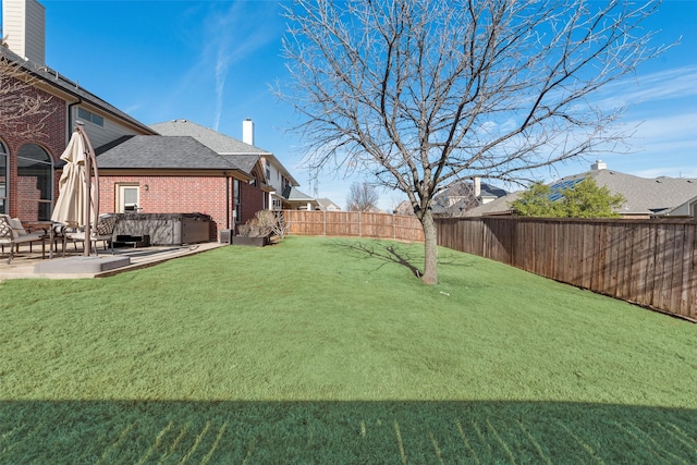 view of yard with a hot tub and a patio area