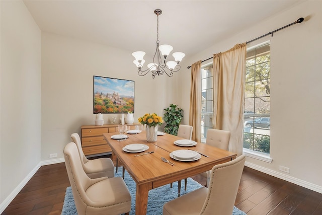 dining room with a wealth of natural light, dark hardwood / wood-style flooring, and a notable chandelier