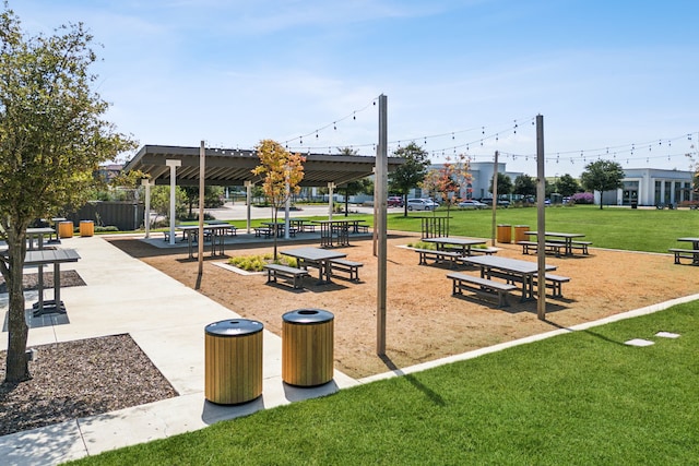 view of property's community with a yard and a pergola