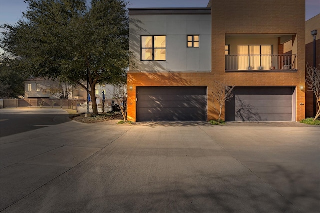 modern home with a balcony and a garage