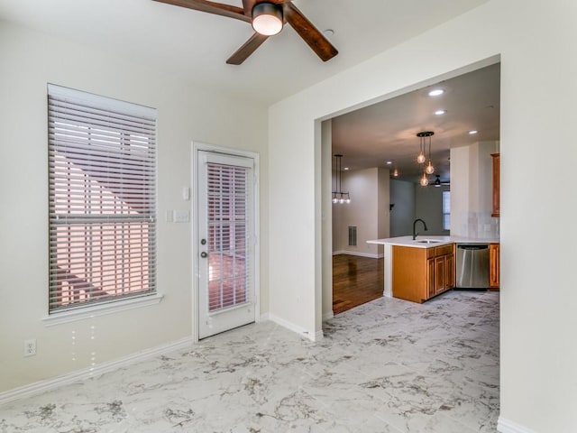 interior space featuring ceiling fan and sink