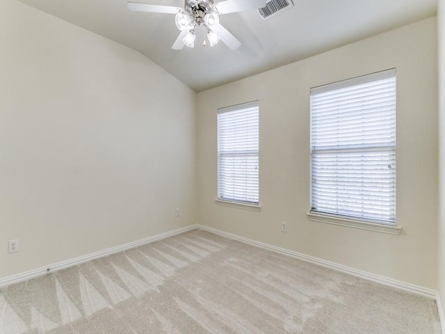 unfurnished room with ceiling fan, lofted ceiling, and light colored carpet