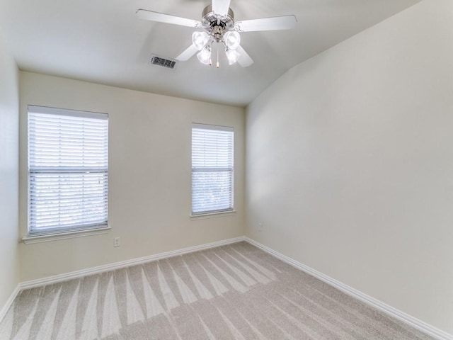 carpeted empty room with ceiling fan and lofted ceiling