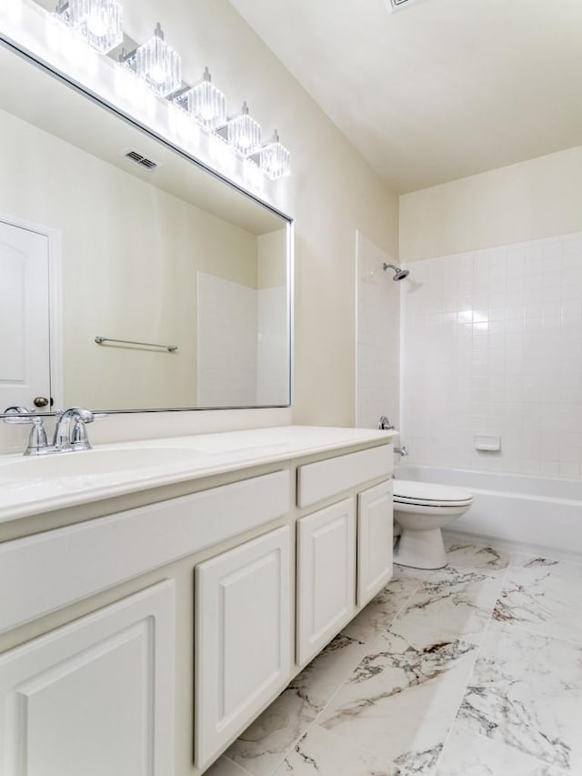 full bathroom featuring toilet, tiled shower / bath combo, and vanity