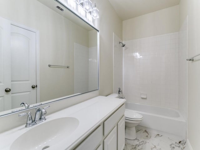 full bathroom featuring tiled shower / bath combo, vanity, and toilet