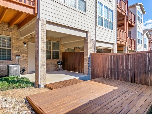 deck featuring central air condition unit and a patio