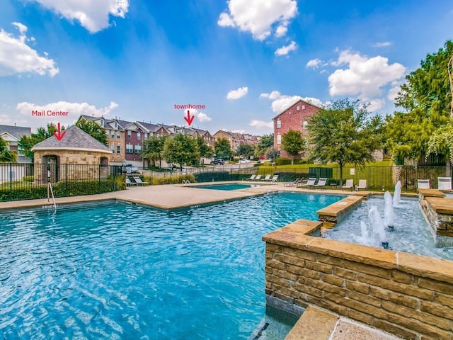 view of swimming pool with pool water feature