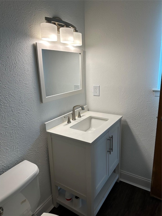 bathroom with toilet and vanity