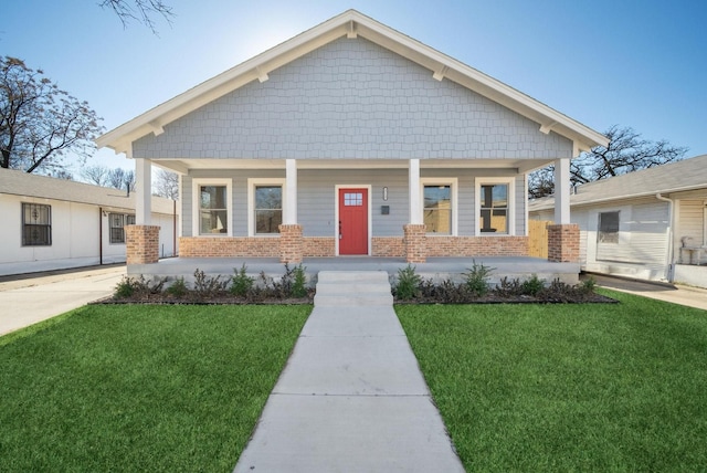 view of front of house with a front yard and a porch