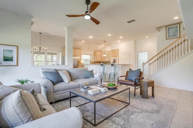 living room featuring stairs, light tile patterned floors, recessed lighting, visible vents, and ceiling fan with notable chandelier