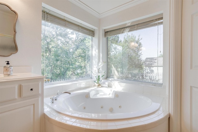 bathroom with a relaxing tiled tub, a wealth of natural light, vanity, and ornamental molding