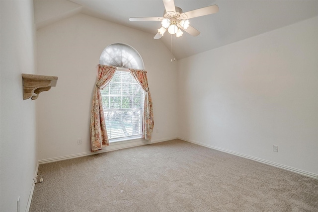 empty room with lofted ceiling, ceiling fan, and carpet