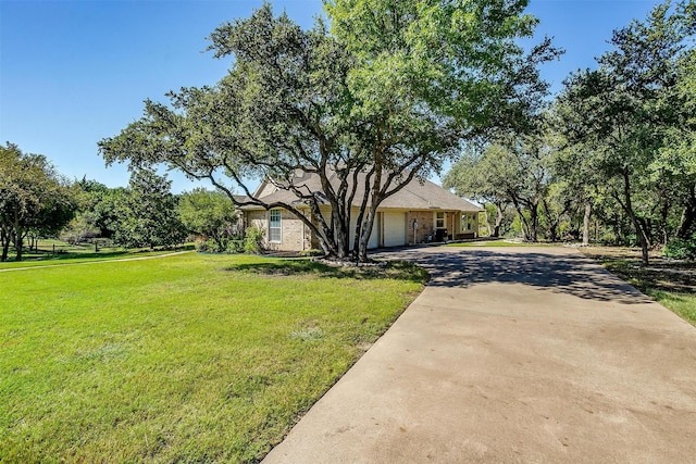 view of front of home with a front lawn and a garage