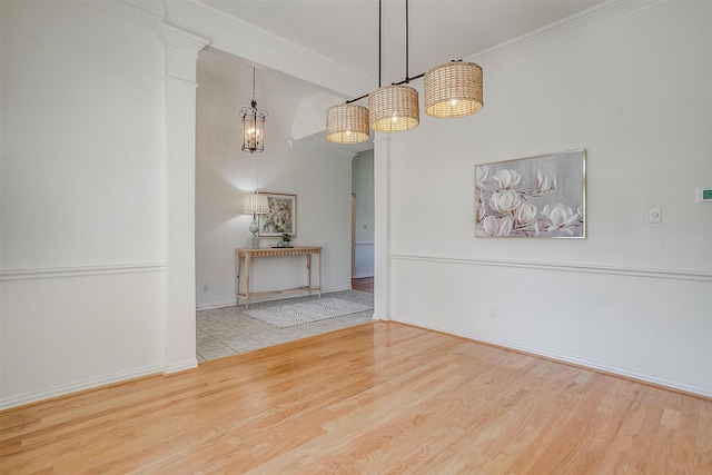 unfurnished dining area with baseboards, wood finished floors, and crown molding